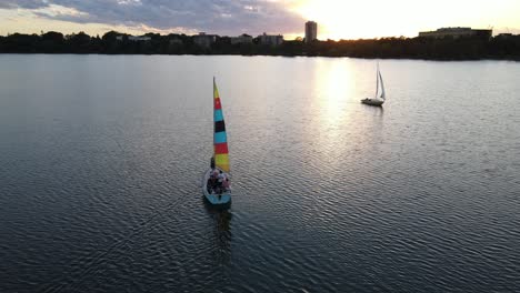 boats at lake bde maka ska during sunset in a summer evening, travel minnesota