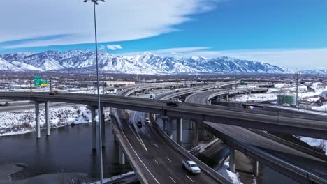drone view of traffic on spaghetti bowl in salt lake city, snowy mountains