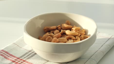 roasted cashews in a white bowl