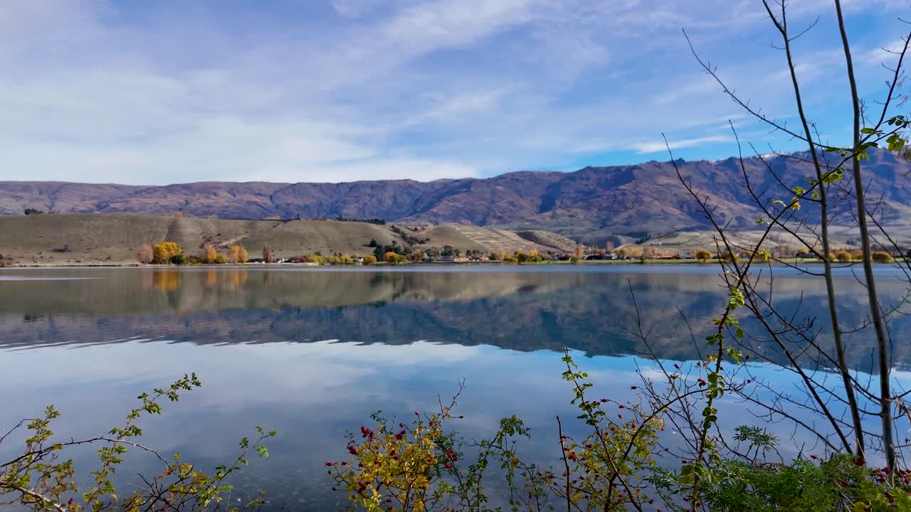 Aerial view of Lake Dunstan with mountains and clear skies, showcasing serene natural beauty and calm waters