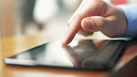 hombre de negocios usando una pantalla táctil de computadora de tableta en un café