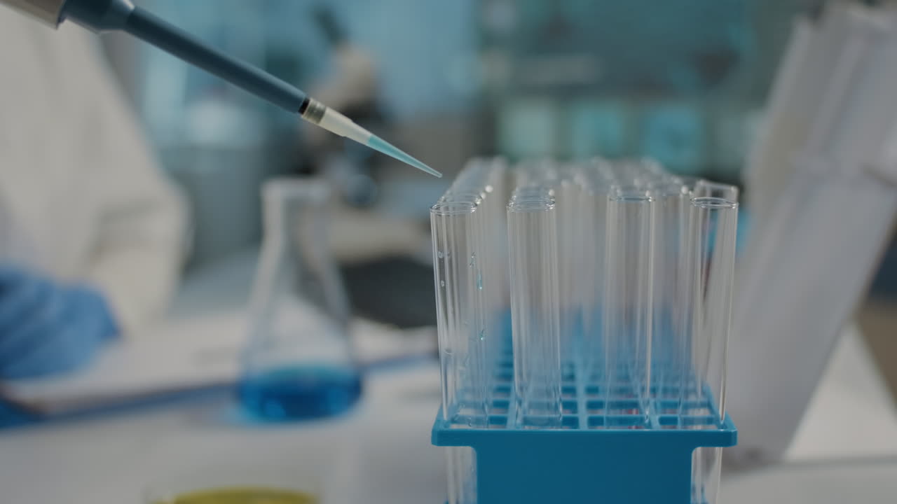 Scientist working with micro pipette and beaker to mix substance
