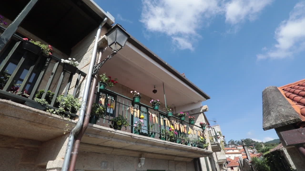 Sunny balcony with colorful laundry and flowers in Pontevedra, Galicia, Spain
