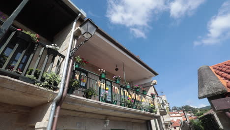 sunny balcony with colorful laundry and flowers in pontevedra, galicia, spain