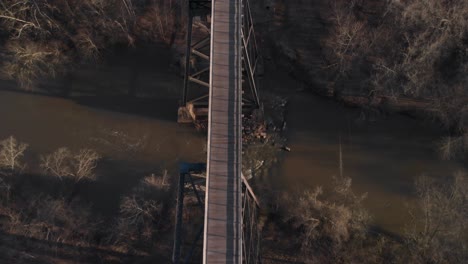 flying directly over high bridge trail, a reconstructed civil war railroad bridge in virginia, looking down to see the appomattox river pass beneath the bridge