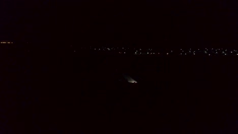 night aerial view of highway and city lights