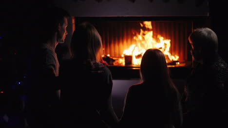 multi-generational family having fun by the fireplace