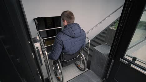 special elevator for the person with a physical disabilities. a man in a wheelchair uses a special elevator