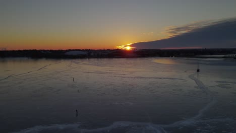 aerial  over a frozen lake during sunrise