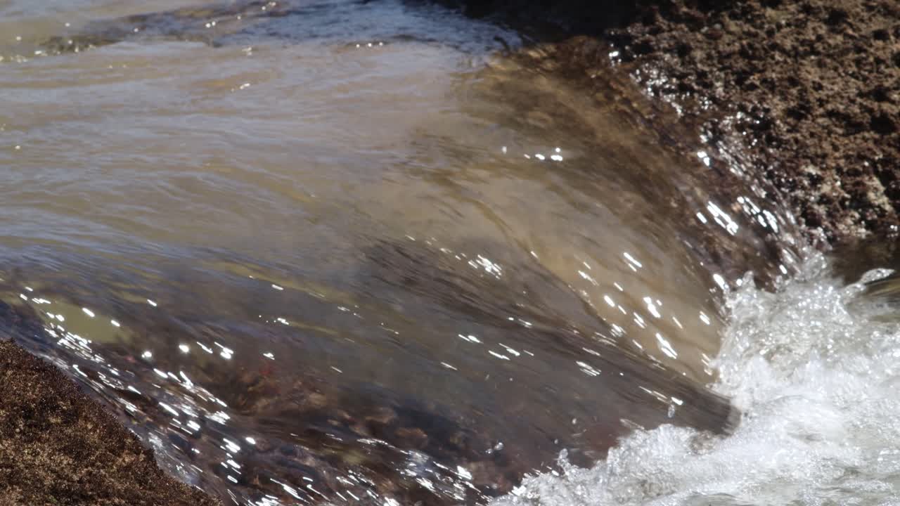 Fast Flowing Ocean Water Flowing Over Rocks as Tide Comes In 4K