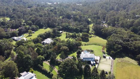 Aerial-view-of-large-countryside-private-properties-with-swimming-pools-and-solar-panels-located-in-a-very-green-area