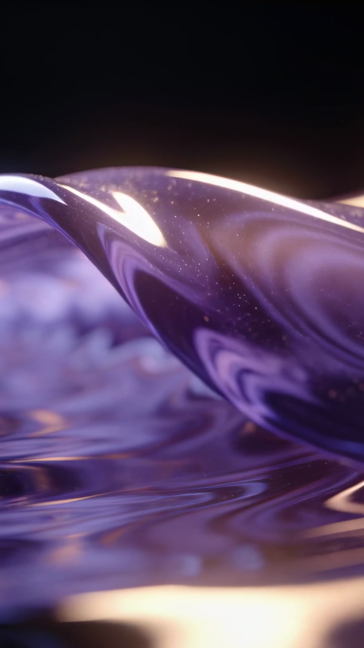 Vertical video: Lifting camera showing purple gel shifting in dark set with warm light and glitter