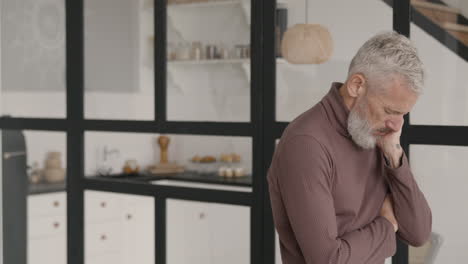 middle aged man having headache at home while his wife trying to comfort him