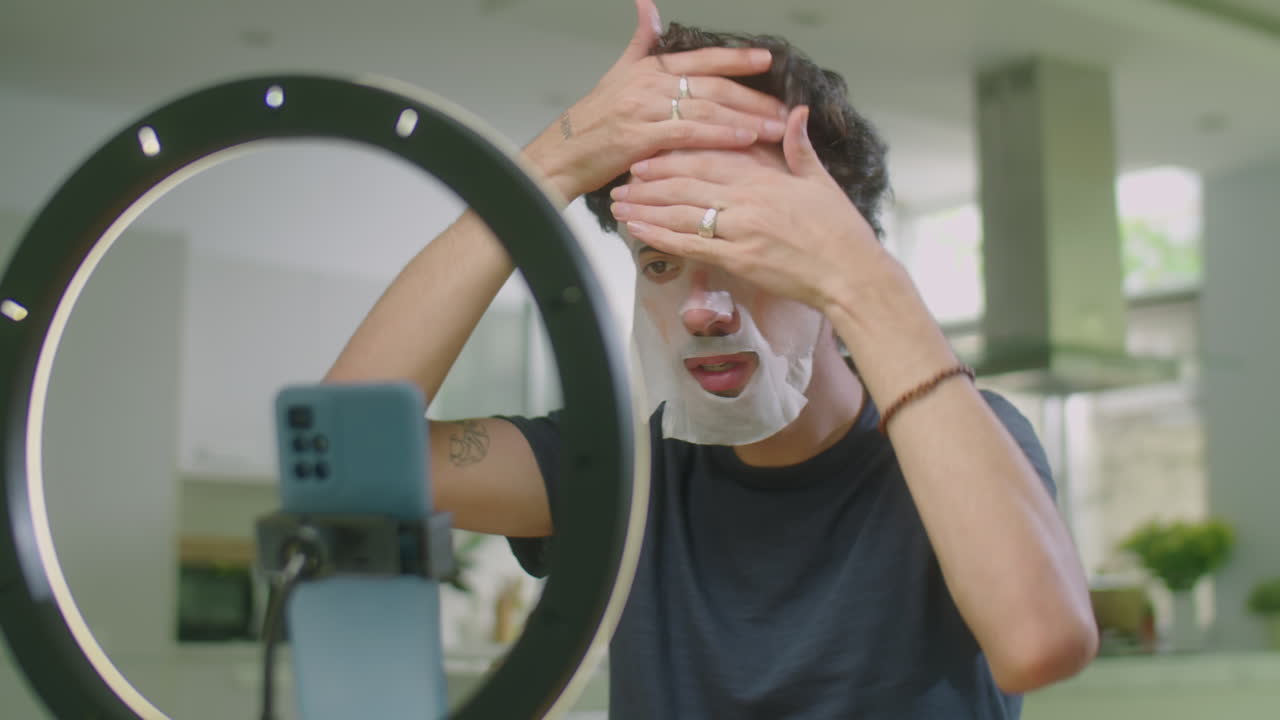 Male Beauty Influencer Applying Sheet Mask