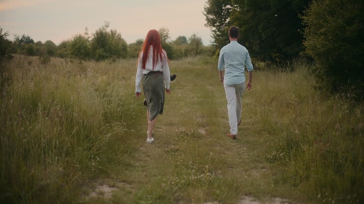 Couple walking in a field