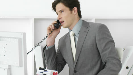 Young-male-executive-talking-on-phone