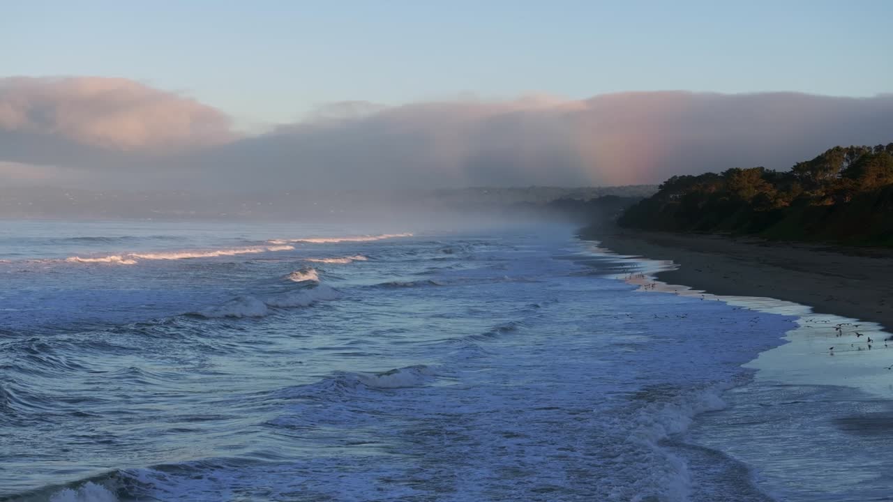 Peaceful Beach Sunrise with Rainbow