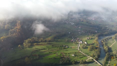 Scenic-view-of-the-countryside-of-Transylvania,-Romania,-seen-from-the-clouds-during-sunset,-high-altitude-shot