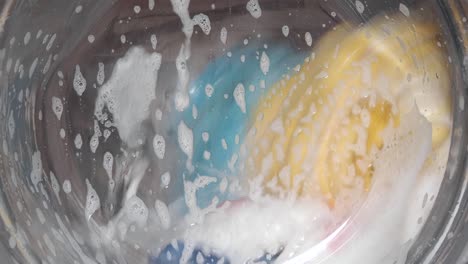 close-up of laundry machine or washing machine with laundry detergent and foam