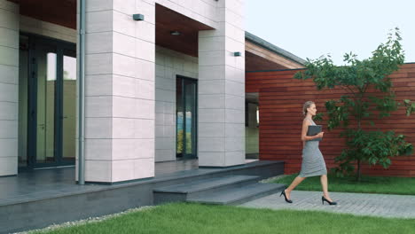 elegant business woman leaving office with laptop. beauty woman going outside