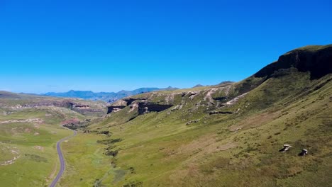 revealing drone shot of a winding road through a hilly national park, showcasing scenic beauty. perfect for nature, travel, and adventure projects