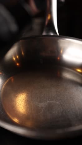 pouring oil into a pan