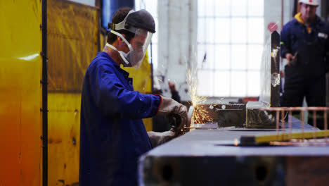 male engineer using grinder machine 4k