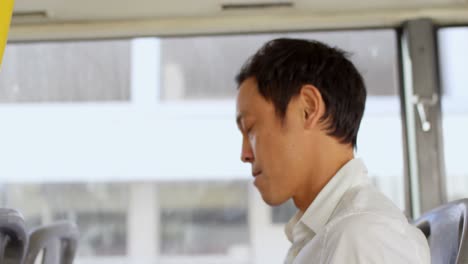 male commuter talking on mobile phone while travelling in bus 4k