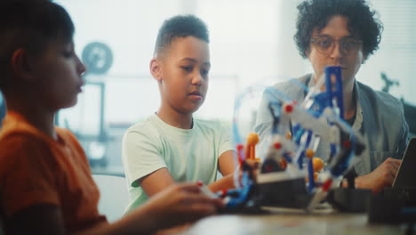 students and teacher working on a robotics project
