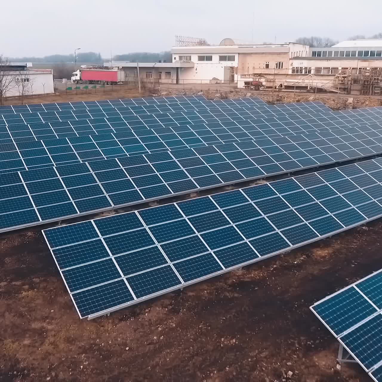 Landscape picture of solar farm. Solar panel produces green, environmentally energy from the sun. Aerial view. Camera motion back.