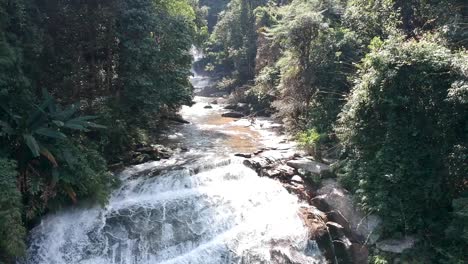 drone footage of waterfall in chiang mai, thailand, with the cliff surrounded by the trees-1