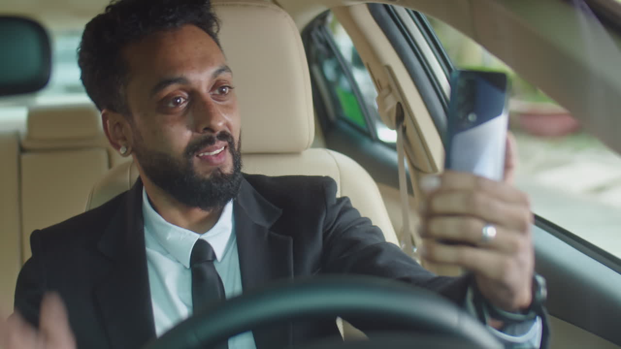 Businessman Talking on Cell Phone in Car