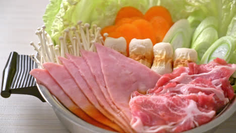 sukiyaki or shabu hot pot black soup with meat raw and vegetable - japanese food style