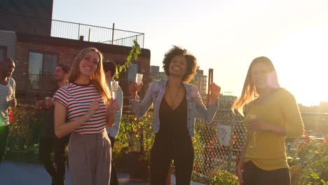 young adult friends dancing at a party on a brooklyn rooftop