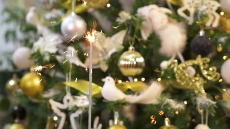 bengal sparkle fire burning with christmas tree behind. slow motion