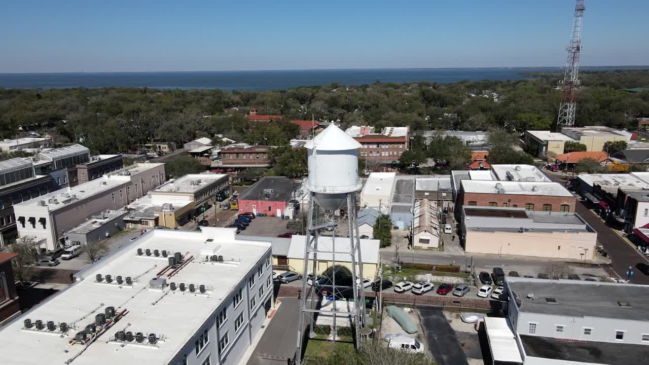 Drone flying around water tower in Florida town