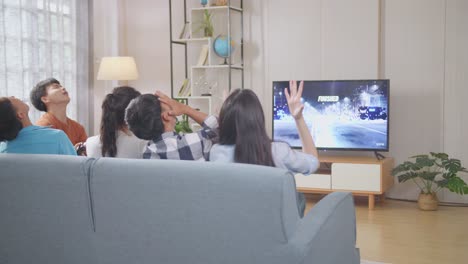 friends watching a video game on tv