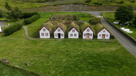 aerial close circular shot of the famous turf houses of iceland