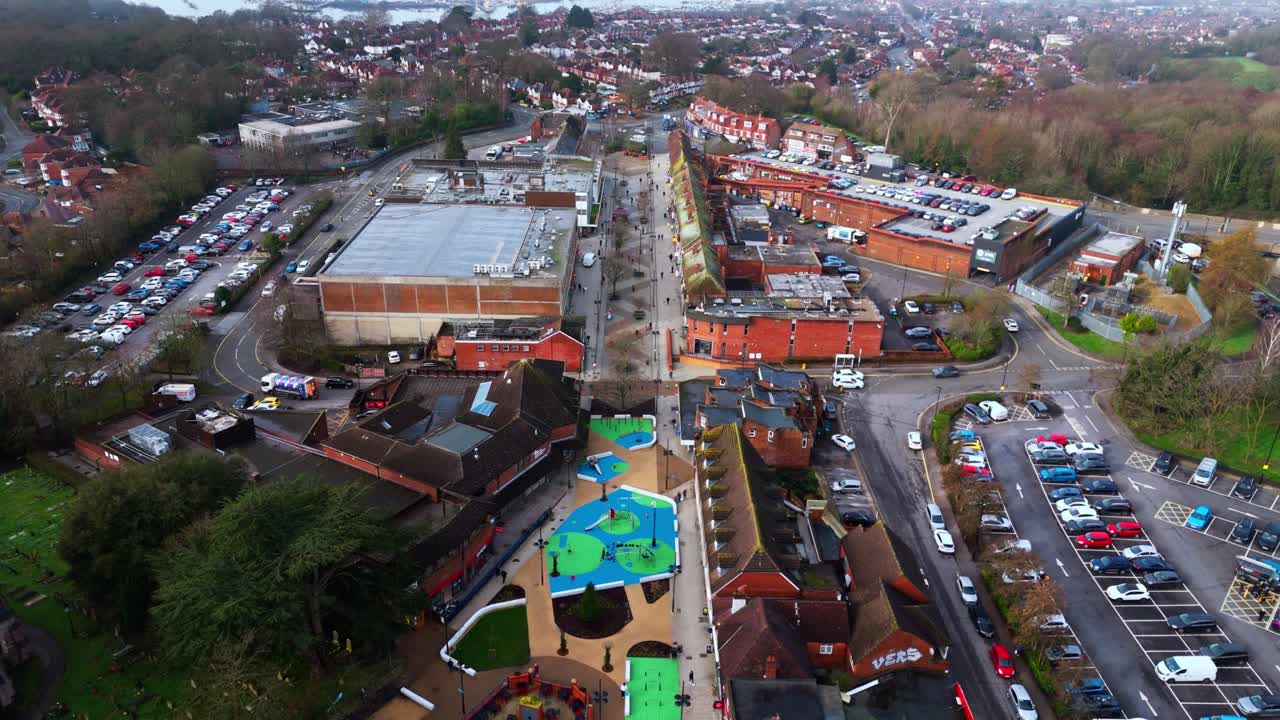 aerial landscape drone shot panning over the Bitterne suburb of Southampton, Hampshire. With lots of houses and fields and trees lining the busy roads in the area on a winters day