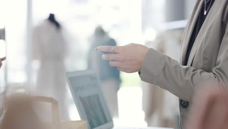 woman paying with credit card at a clothing store