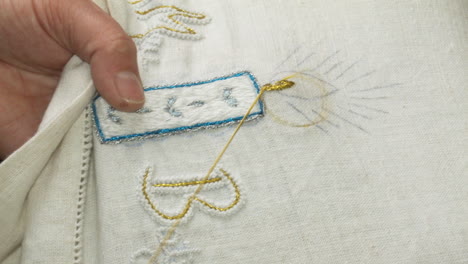 a person embroidering a piece of fabric