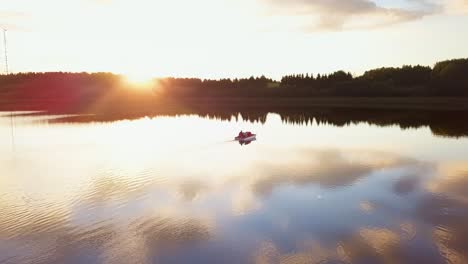 family on a pedal boat on a lake at sunset