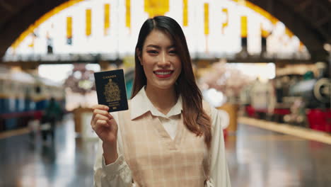 happy woman holding canadian passport in a museum