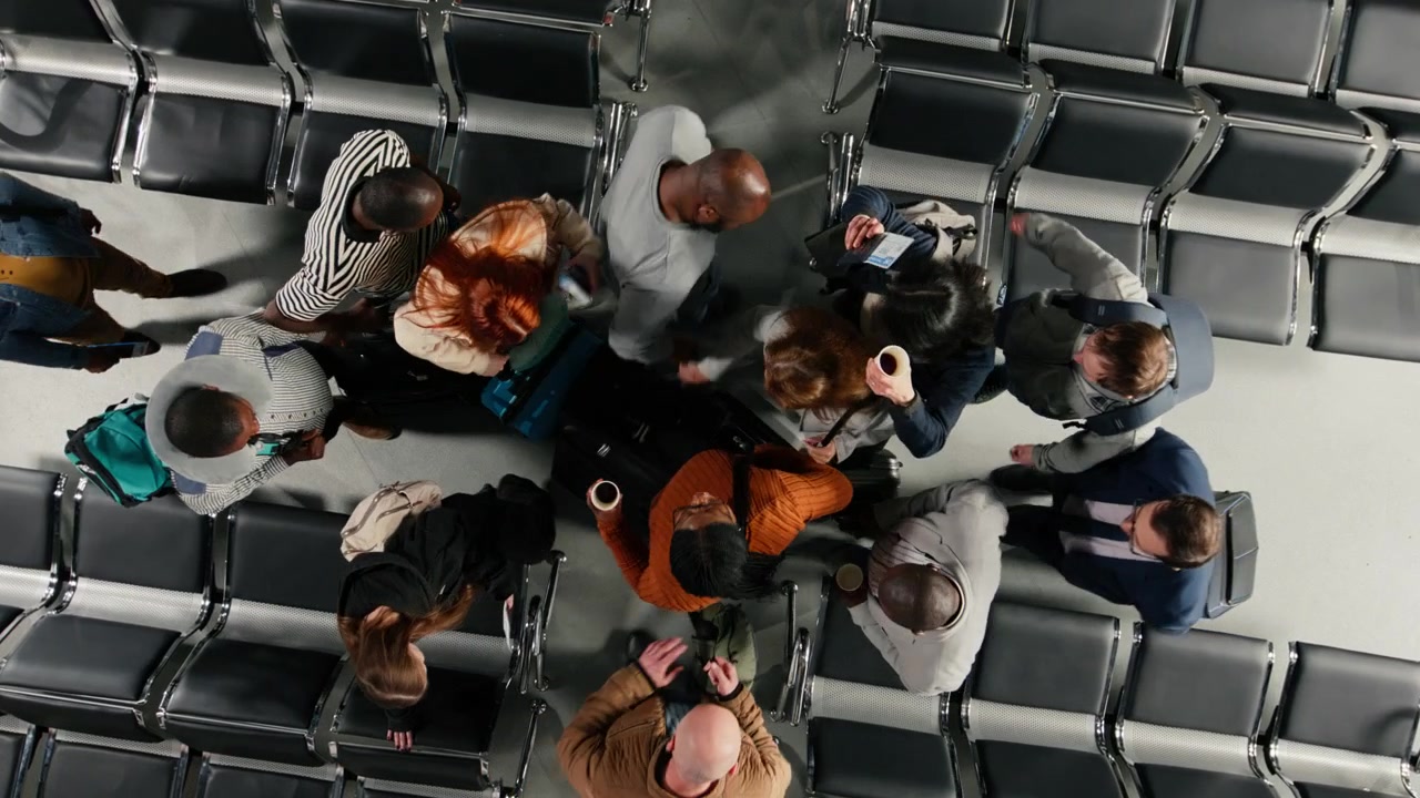 Passengers in busy airport creating congestion while carrying trolleys