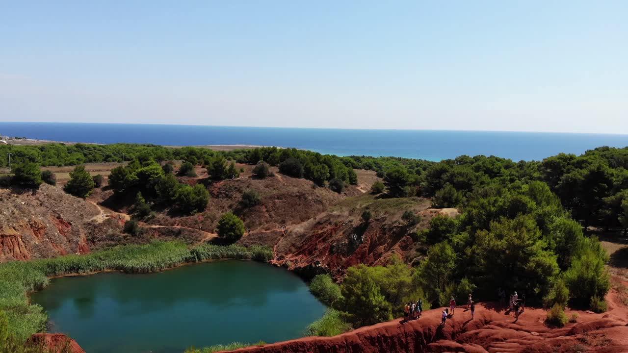 Cava di Bauxite slowly revealed by drone flying backward