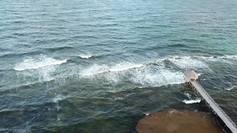 Foamy-Waves-Splashing-At-The-Shore-In-Vidanta-Riviera-Maya,-Quintana-Roo,-Mexico---aerial-drone-shot