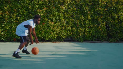 man playing basketball outdoors