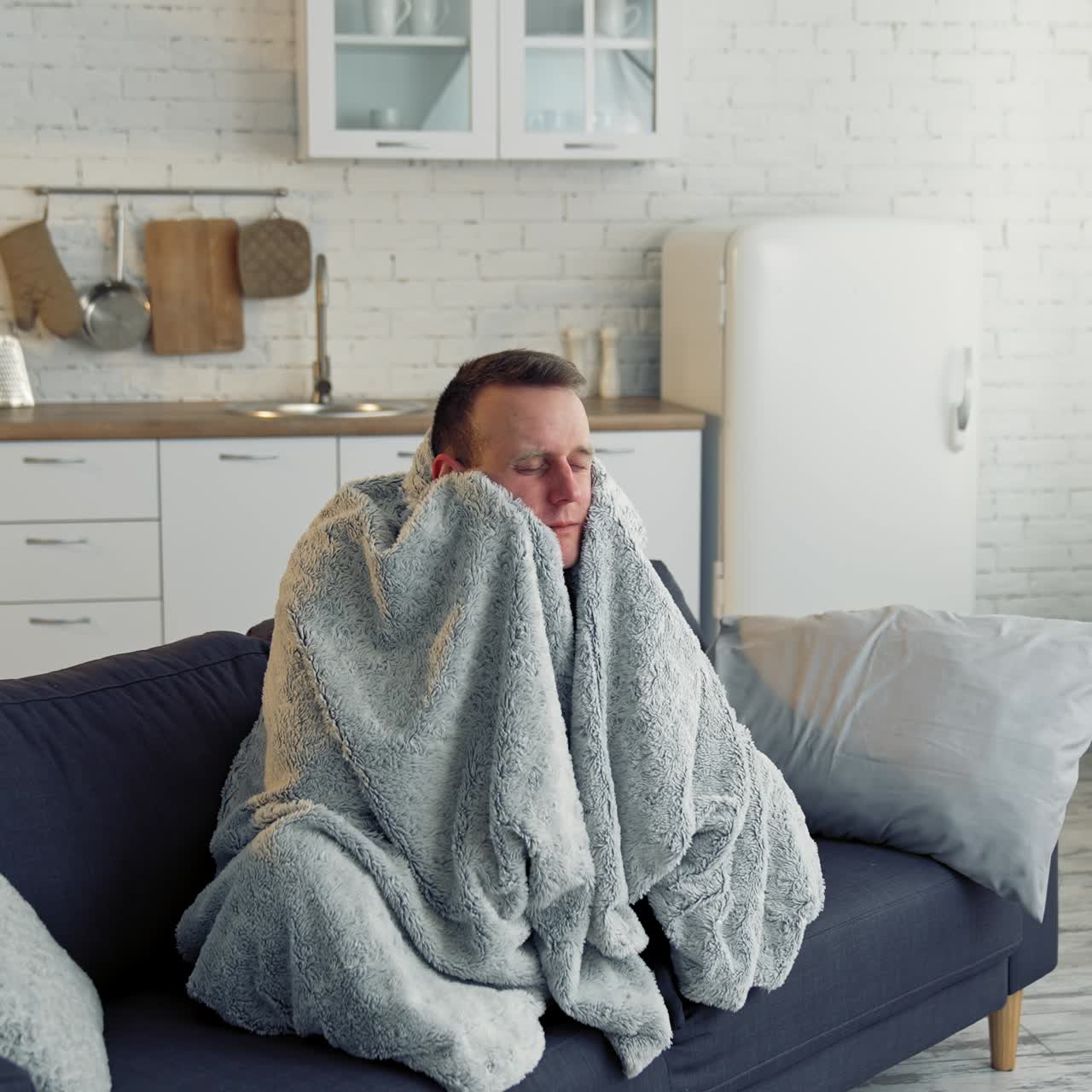 Sick young man suffering from flu at home. Pandemic. Quarantine concept