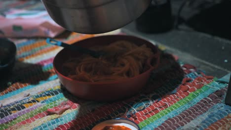 cooking pasta with a portable gas stove in a cottage in the nature, outdoor, camping