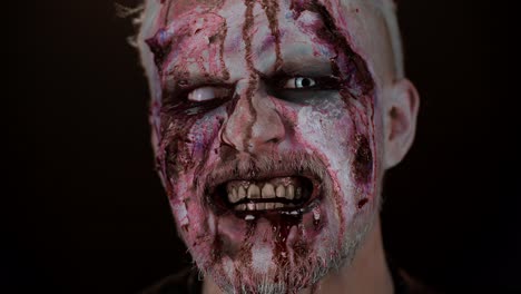 zombie man face makeup with wounds scars and white contact lenses blood flows and drips on face